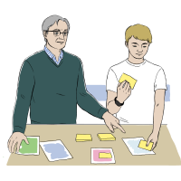 En lærer og en elev arbejder ved et bord